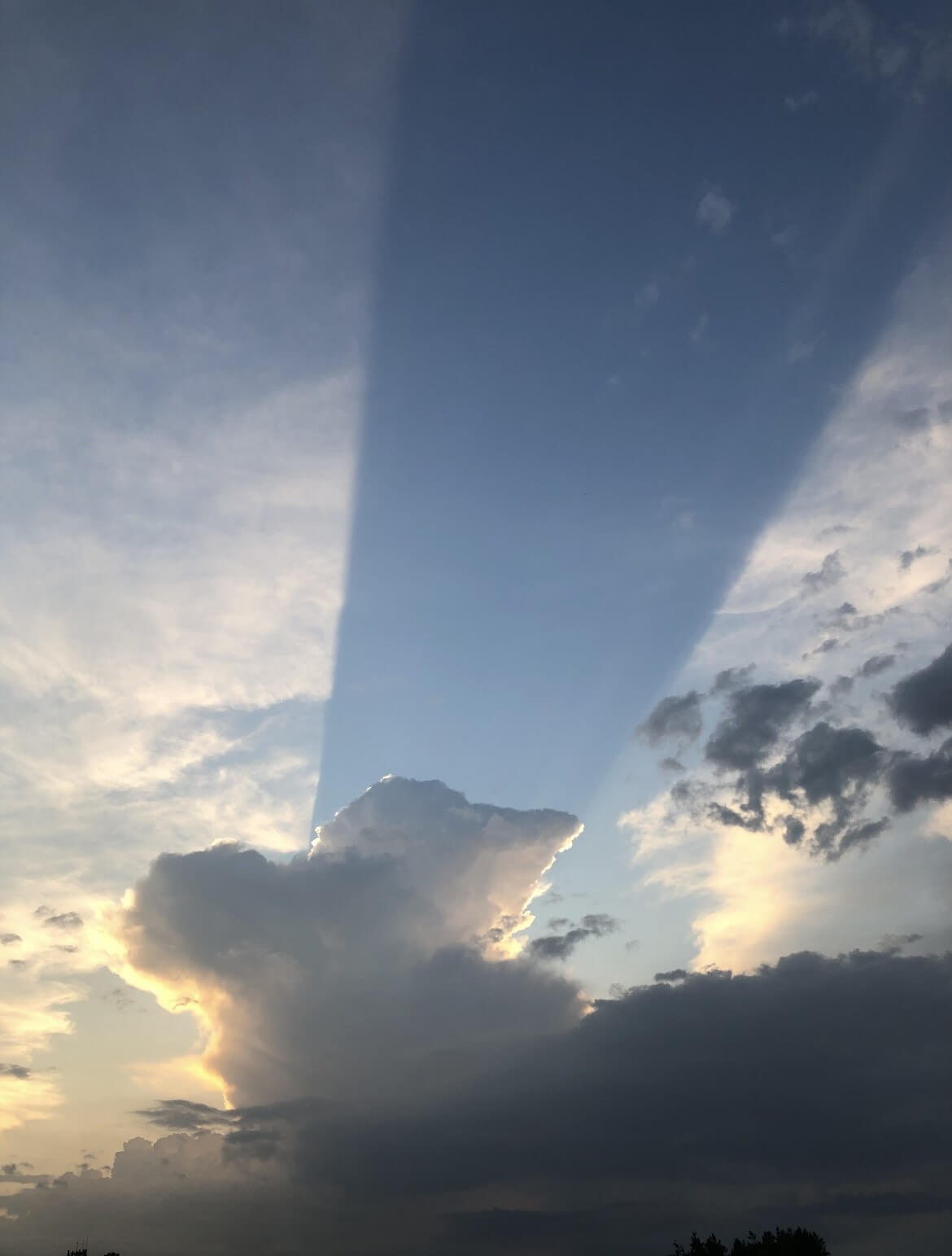 A few years ago the sky after a round from the patio (a shadow of the rain cloud in the distance apparently).